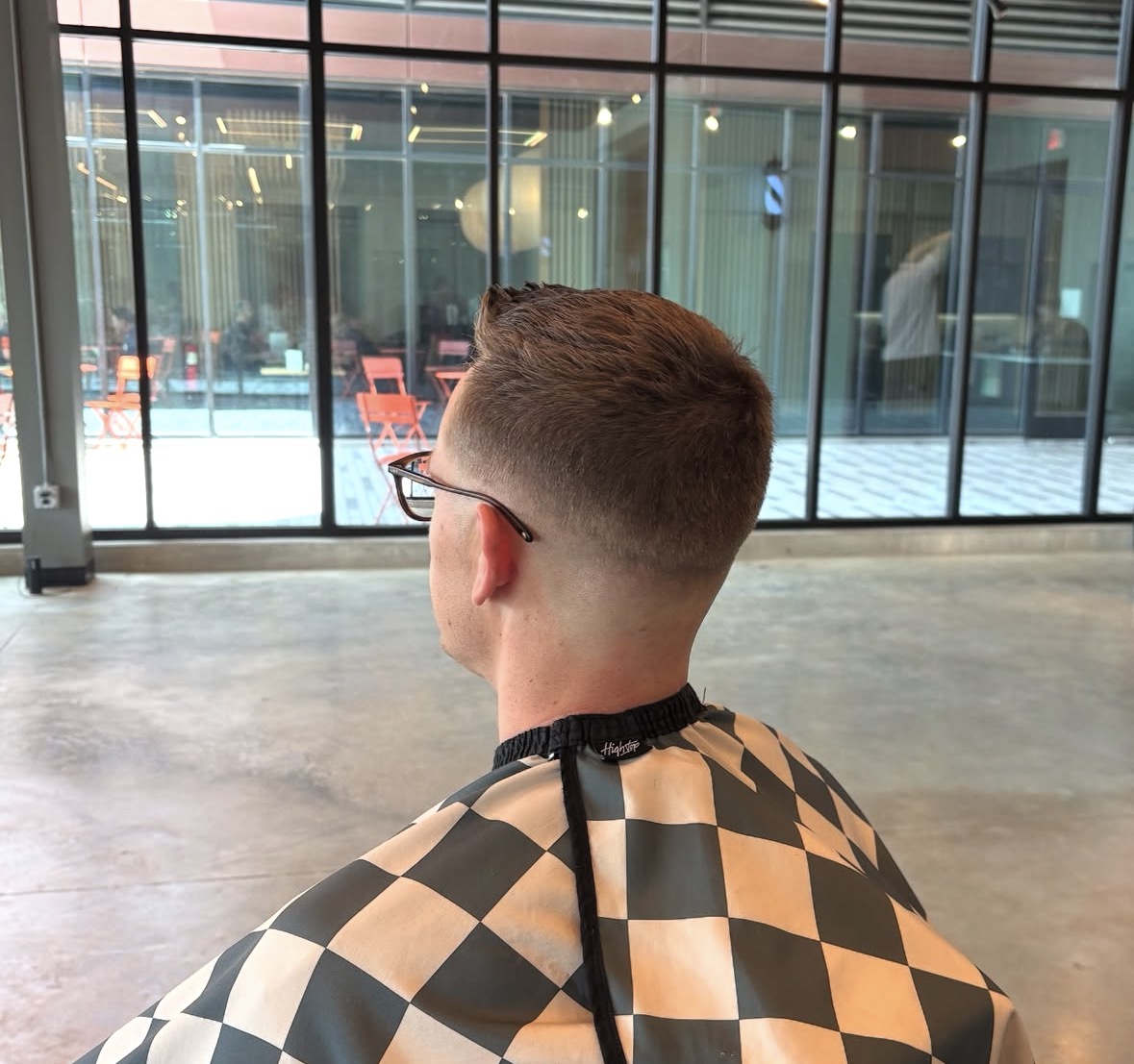 Back view of a fresh taper fade with a textured top at The Cave, Rogers AR
